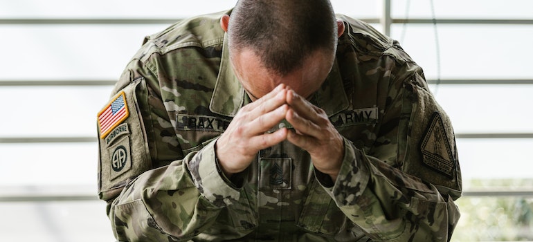 Man in uniform crying.