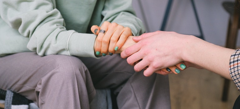 therapist holding client's hand