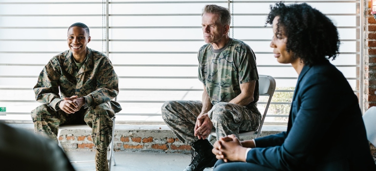 a diverse group of veterans sitting in a circle at an inpatient alcohol detox center in Texas.