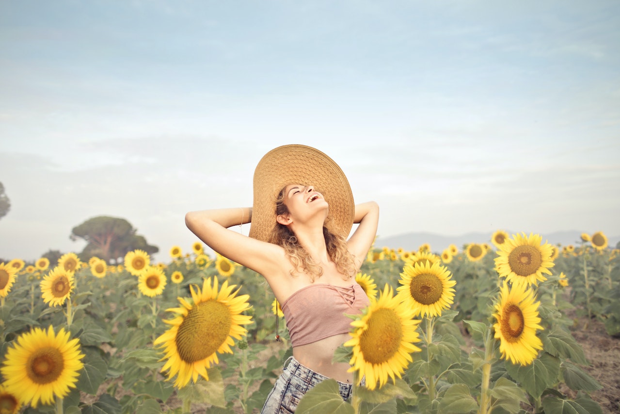 An illustration of a happy woman among sunflowers