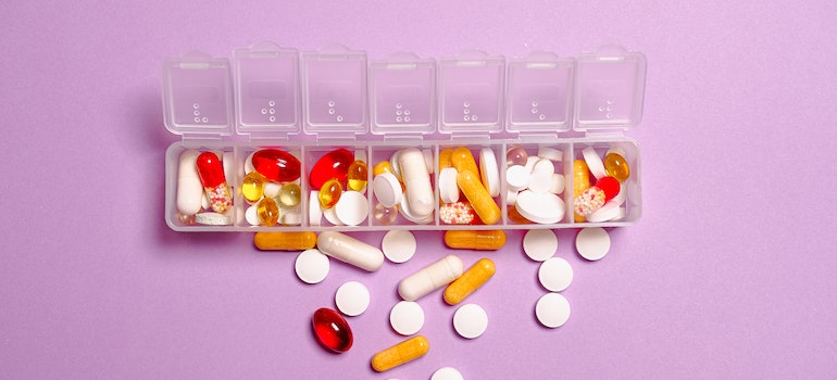 Various pills in a plastic container for dosing representing Xanax abuse and increased anxiety