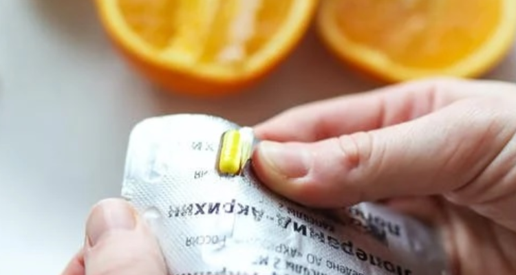 A close-up of a person holding a packet of tablets representing medications used in addiction treatment